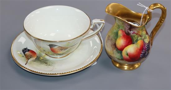 A Royal Worcester cream jug painted with fallen fruits by Harry Ayrton and a Stonechat cup and saucer